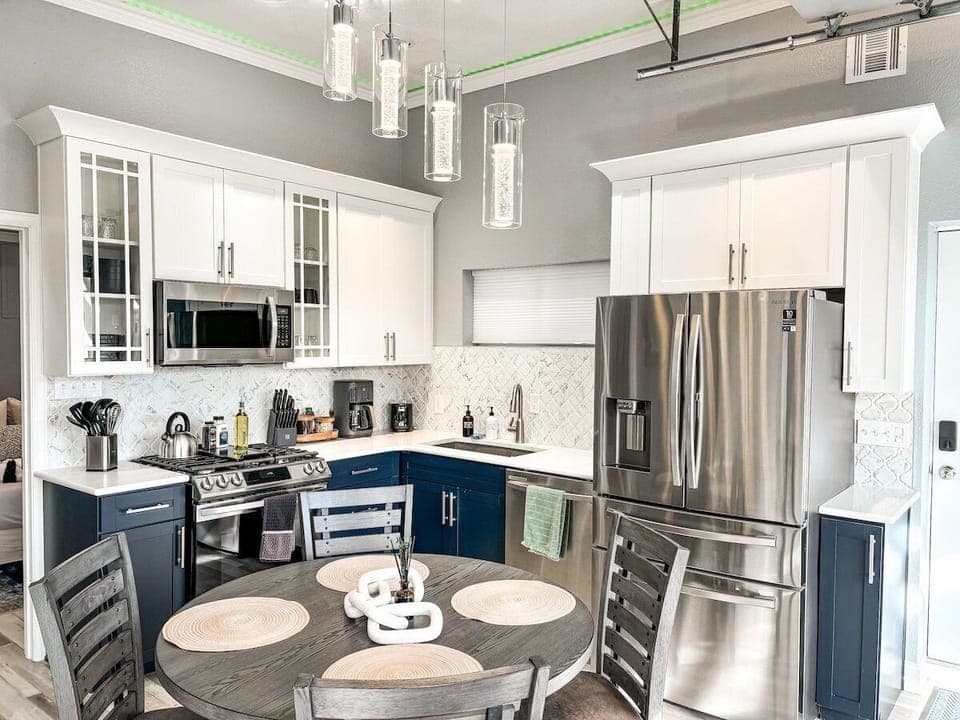 The kitchen is fully equipped for everyday cooking and includes all essential cookware, appliances, and a dining table with seating for four.