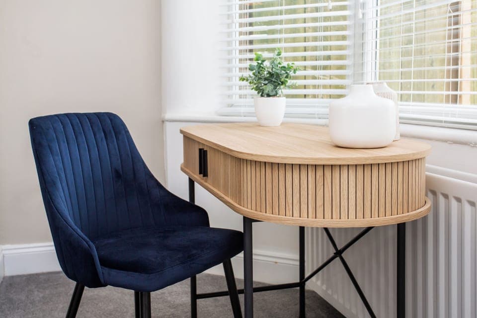 Nestled next to the dining area, this charming seating nook offers a peaceful retreat for reading, working, or simply enjoying a quiet moment.