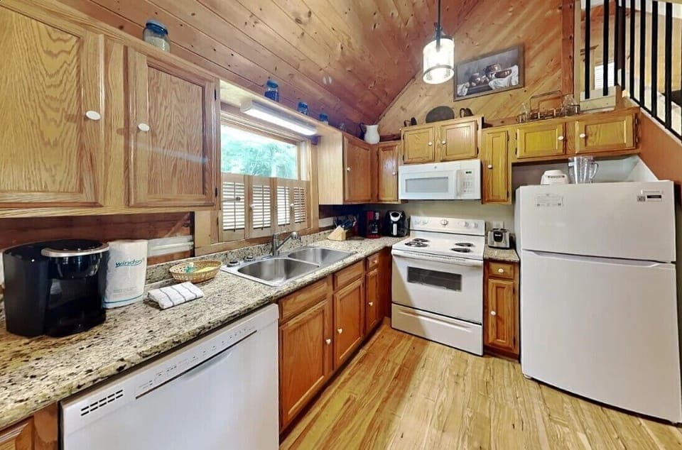 Kitchen with updated utensils, coffee maker, refrigerator, stove/oven, microwave