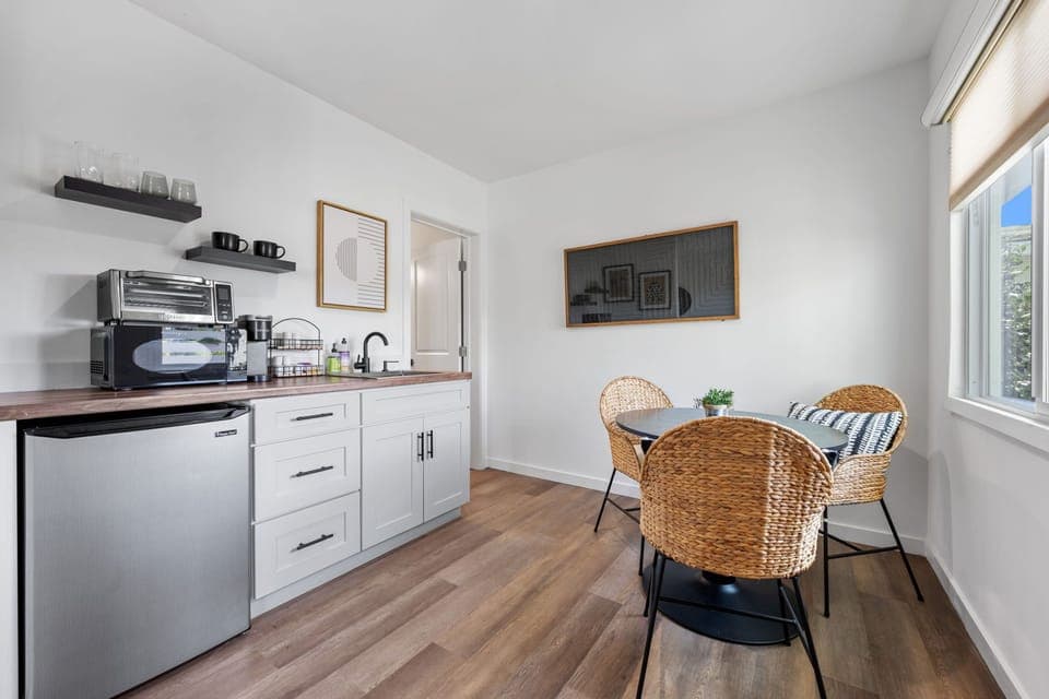 This modern, well equipped kitchenette with a small fridge, microwave, toaster oven/air fryer combo, and Keurig coffee maker -perfect for effortless meals and morning coffee.