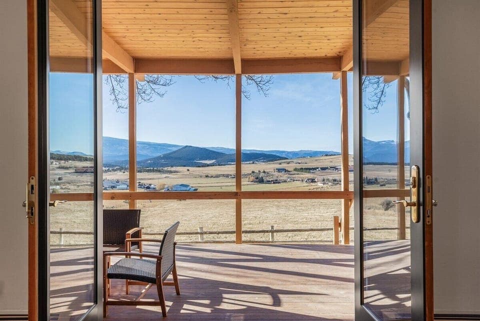 Large double doors opening up to your expansive covered porch with views of the entire valley.