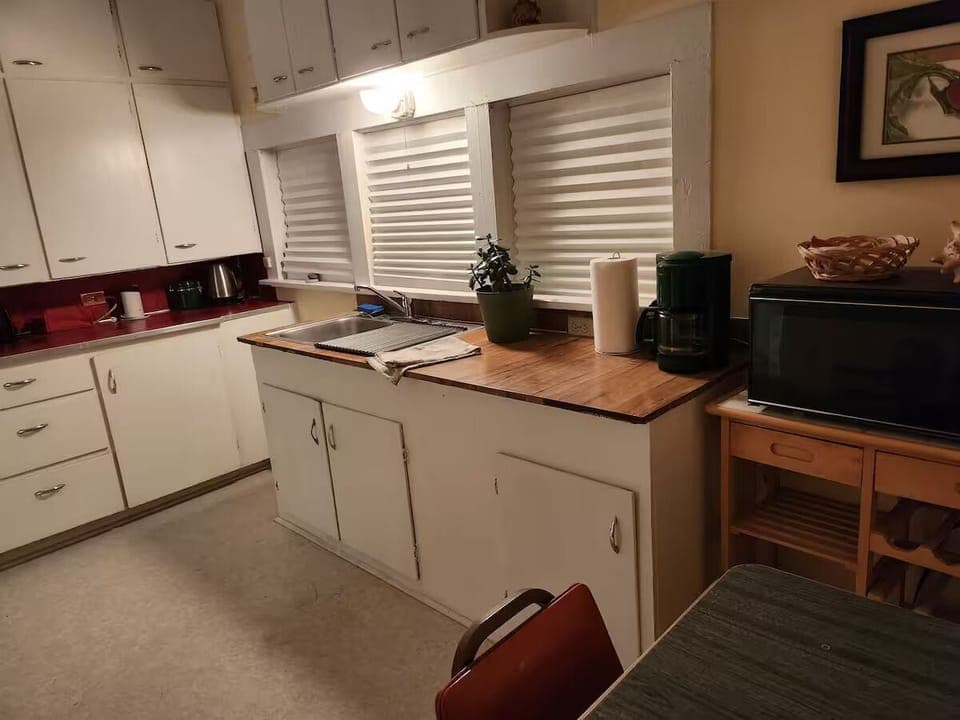 Kitchen with small range, microwave, toaster, coffee maker