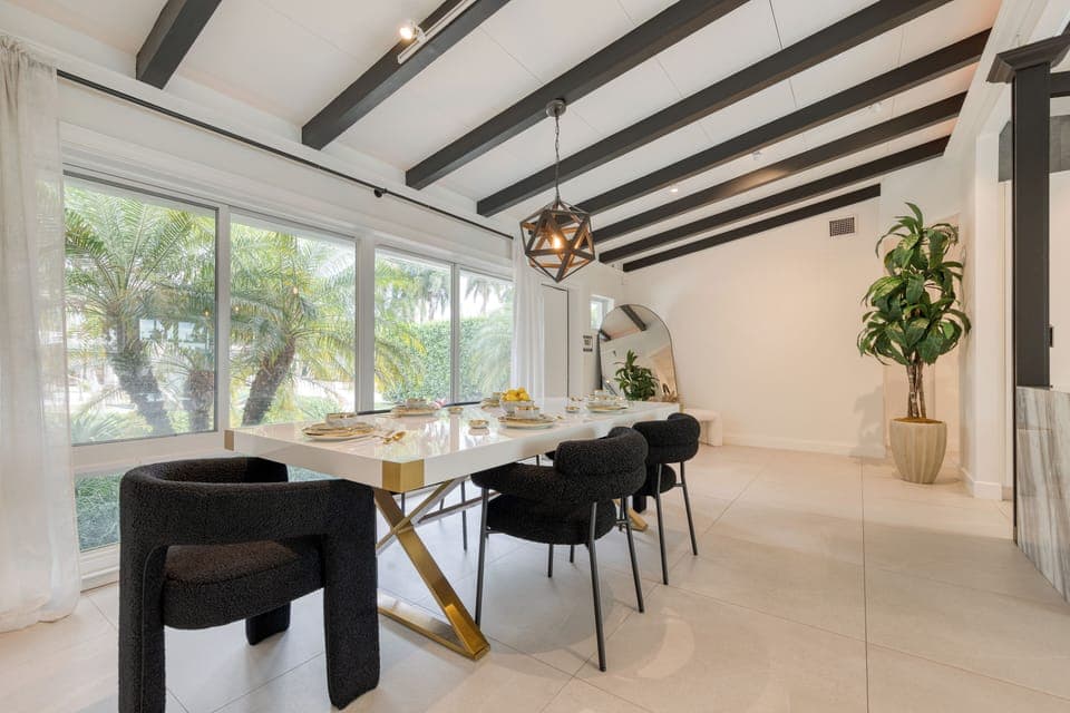 The dining area overlooks the pool, offering a relaxing and scenic backdrop for every gathering.