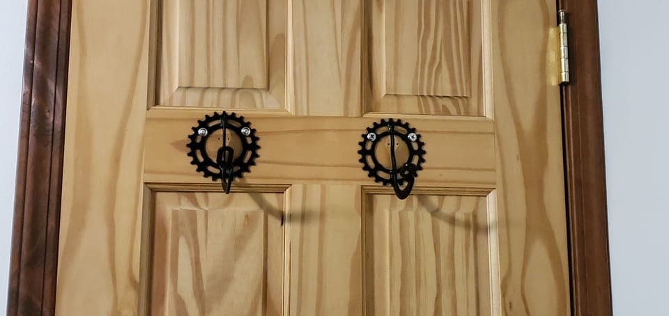 Bike parts make up the hooks on the back of the door in the Bike room