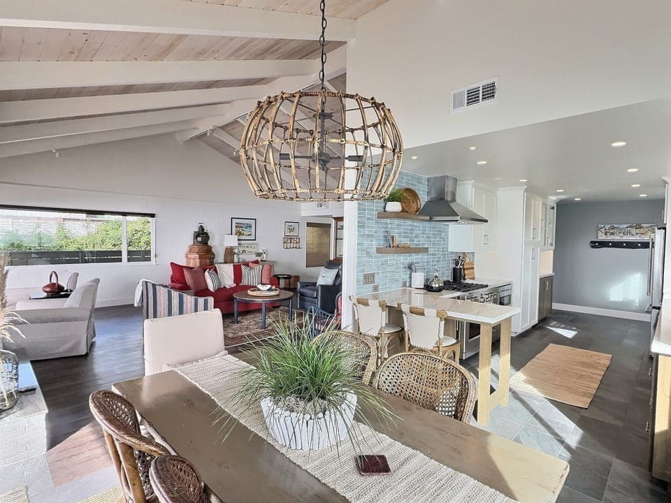 The open layout leads to a dining table for six with endless ocean views. Step onto the patio for al fresco meals, cozy up by the fire table, or grill with sunset skies.