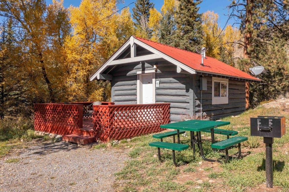 Arrive to your private cabin framed by golden mountain aspens.