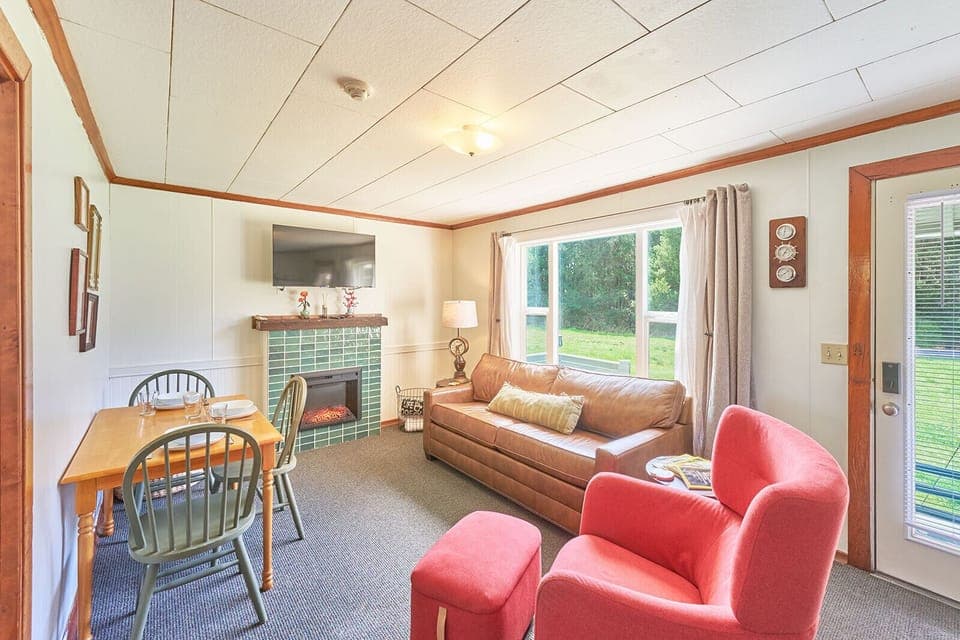 Bright and cozy living room with a comfy queen sofa bed — perfect for extra guests. 🛋️☀️