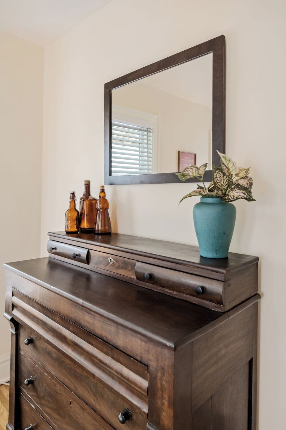 Primary bedroom with king bed, seating, dresser, closet, ceiling fan, and smart TV.