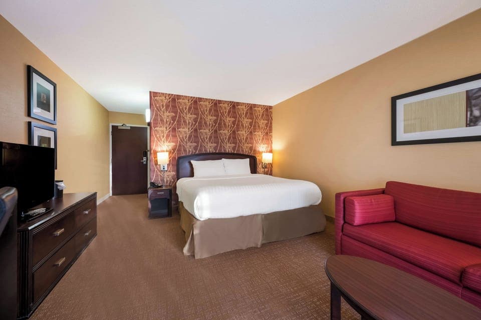Recharge deeply in a serene king room with warm lighting.