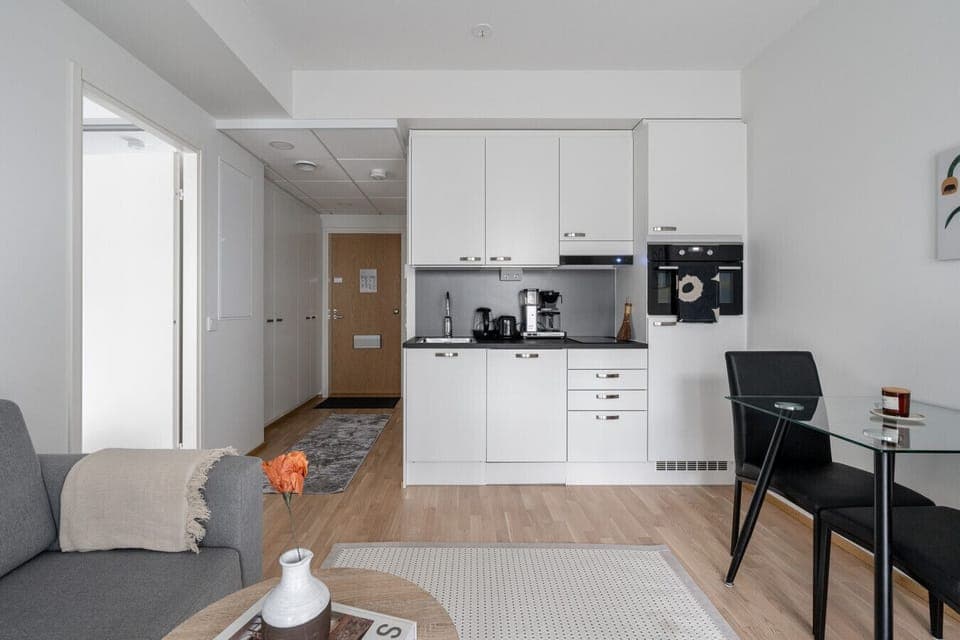 The open-plan design connects the kitchen directly to the living area, creating a social space where you can cook while still being part of the conversation.