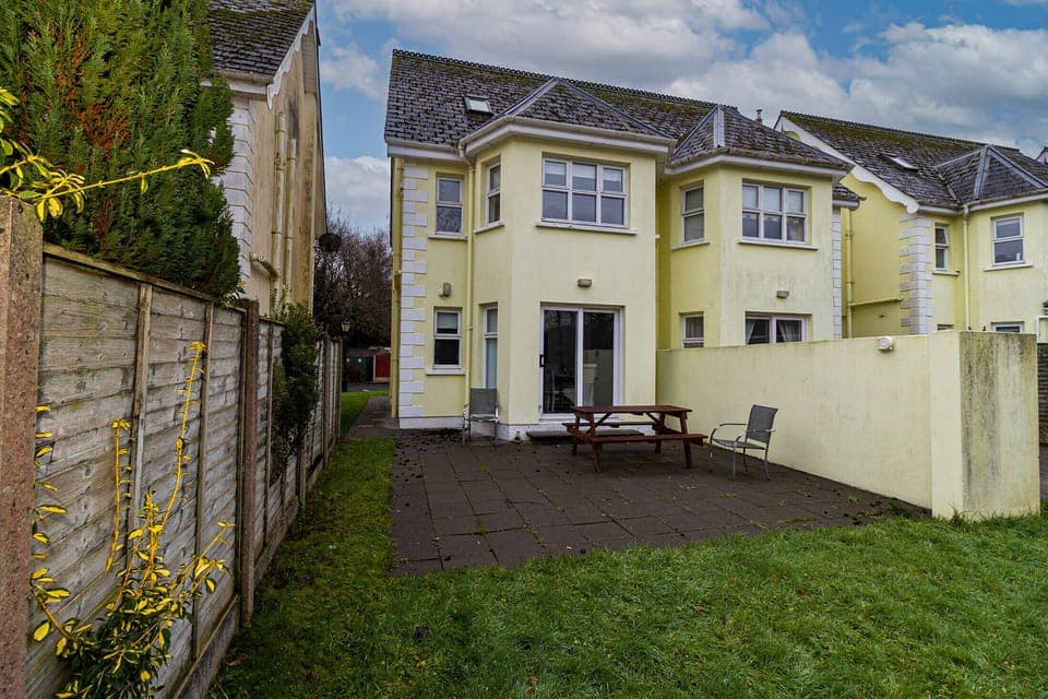 Aughrim Holiday Village No. 14. Aughrim holiday village. Rear with patio outside dining and garden.