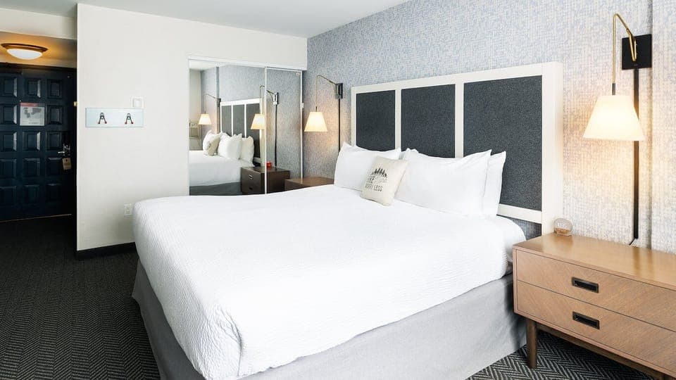 Unwind in crisp linens and a calm, modern bedroom.