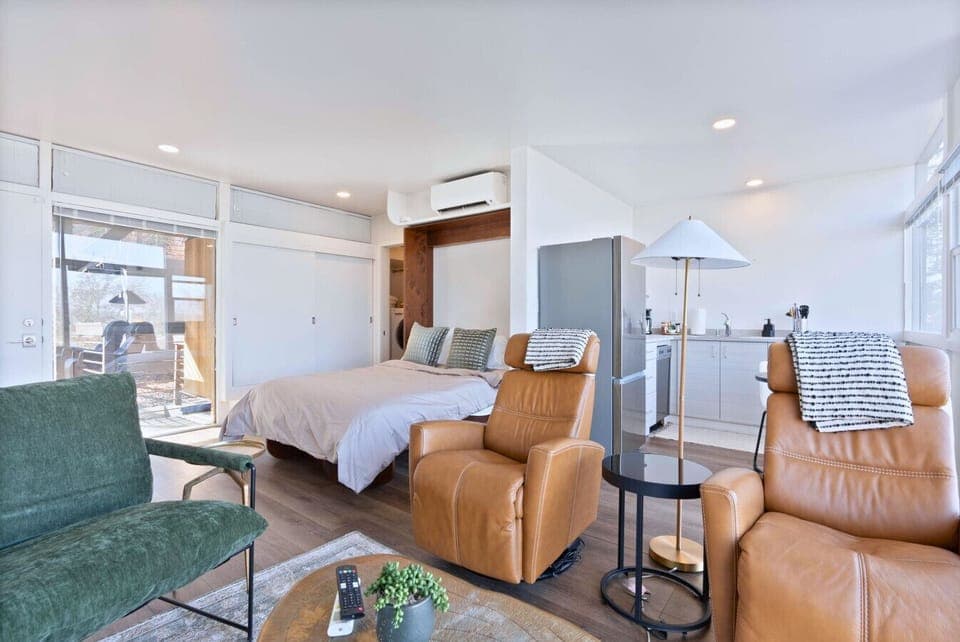 A bright and airy studio featuring a sleek Murphy bed