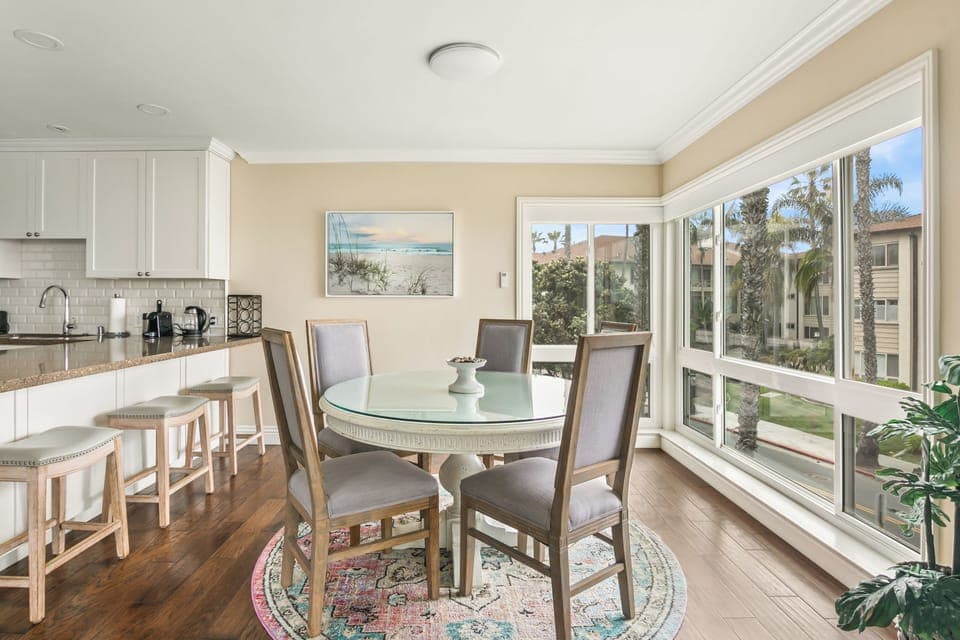 A cozy dining area for four with stunning natural light and ocean views to enhance every meal.