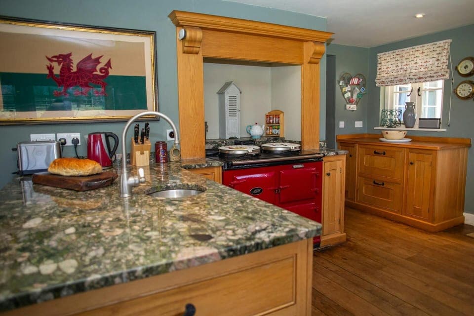 Kitchen with red Aga, kettle, toaster and sink