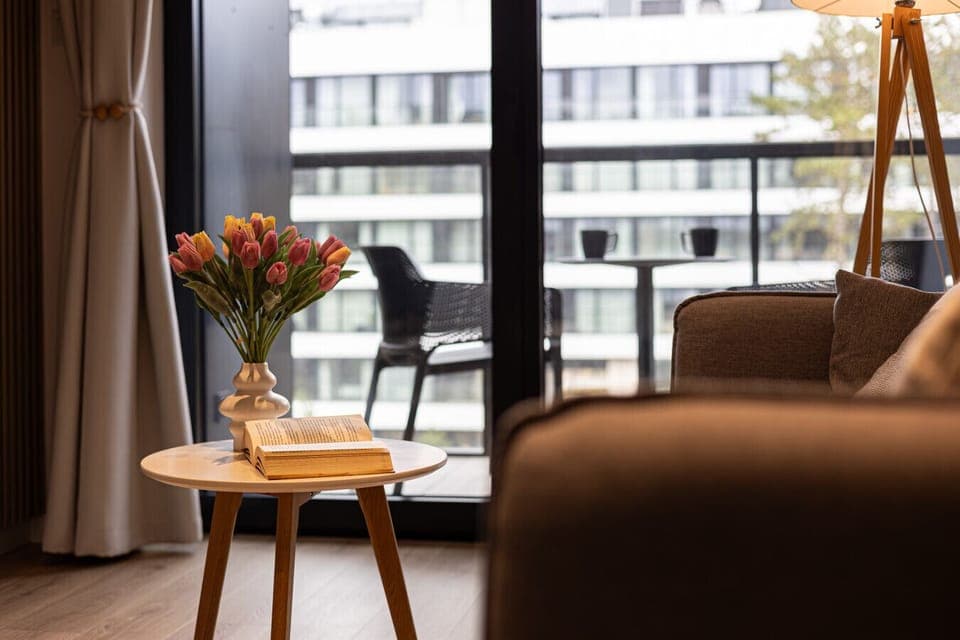 A cozy living room with a comfortable sofa, perfect for an evening with a book. Soft lighting and a warm ambiance invite relaxation.