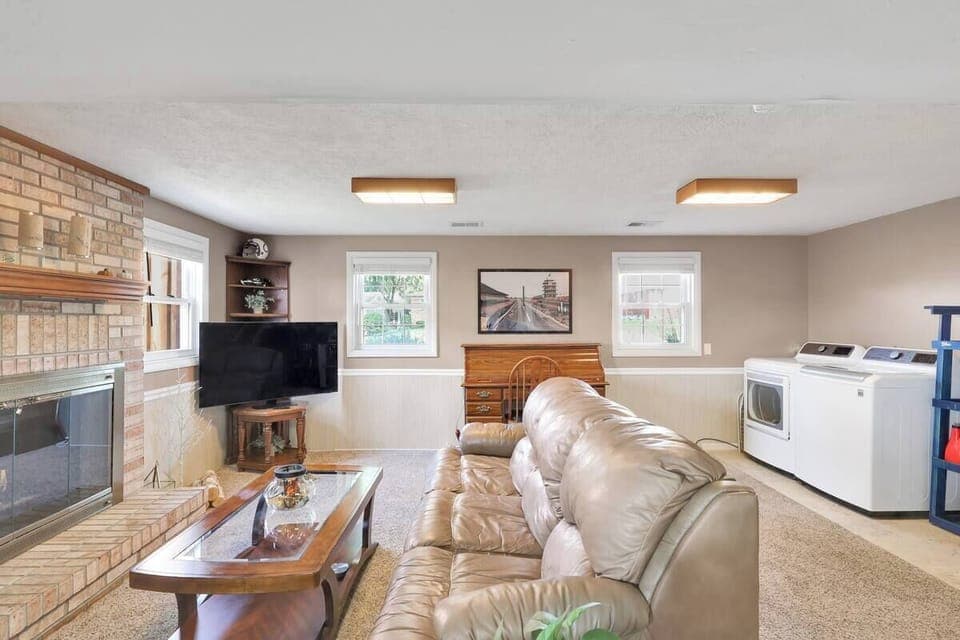 Family room with washer and dryer with 55 inch tv
