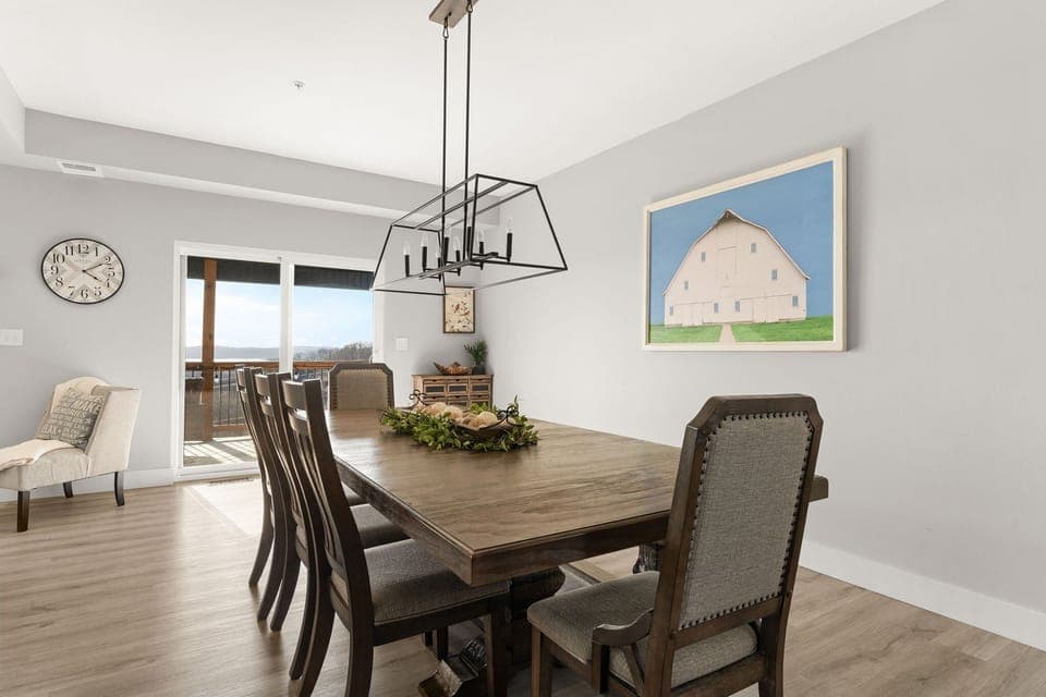 - Gather around the large rustic dining table for family meals or game night
- Charming decor and statement lighting set a warm, inviting scene
- Easy access to the deck makes outdoor dining a breeze