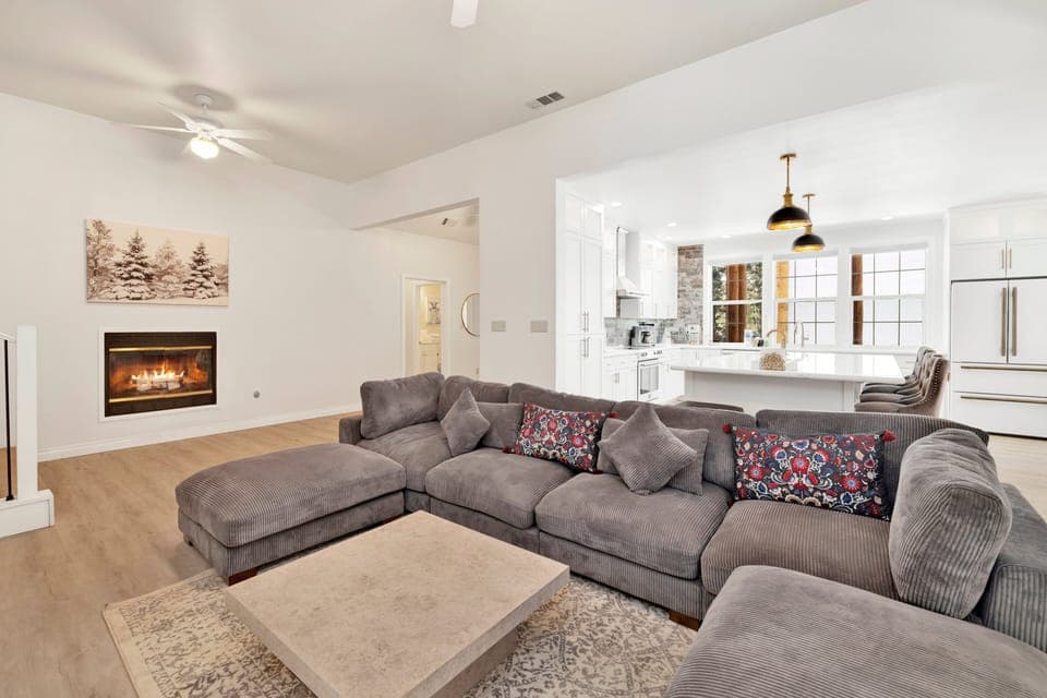 Cozy mountain living room with a fireplace, comfy seating, and smart TV—perfect for relaxing evenings, movie nights, and warm cabin vibes after outdoor adventures.