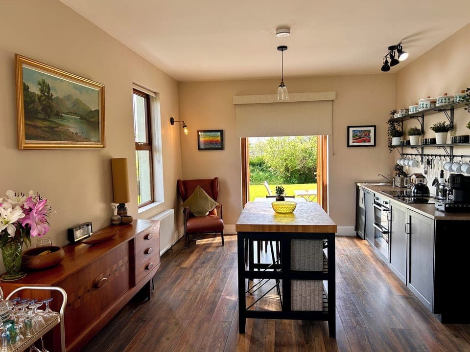 Kitchen/dining area seats 4 at table & 2 at centre island & opens out onto patio