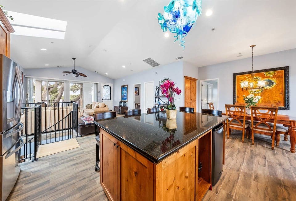 Inviting kitchen featuring rich wood cabinetry a spacious island with seating