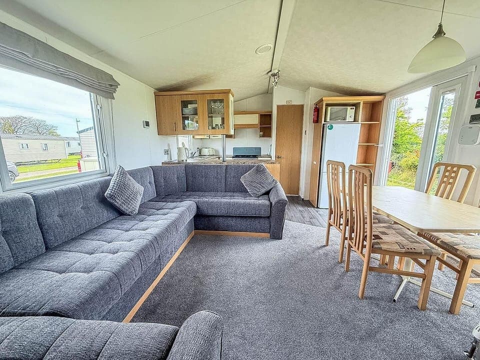 The caravan living room in our holiday homes to rent is designed for comfort and relaxation during your caravan holiday.