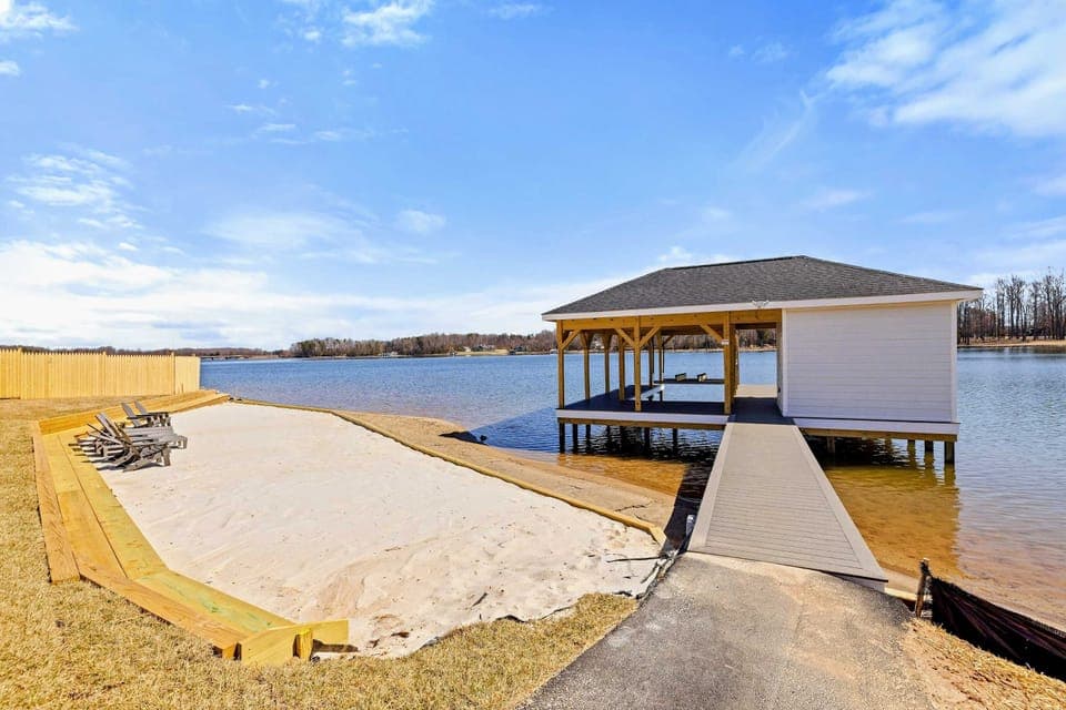 Private Beach and Dock: Enjoy serene lakeside relaxation on your own private sandy beach, complete with comfortable seating and direct dock access for boating and water activities.