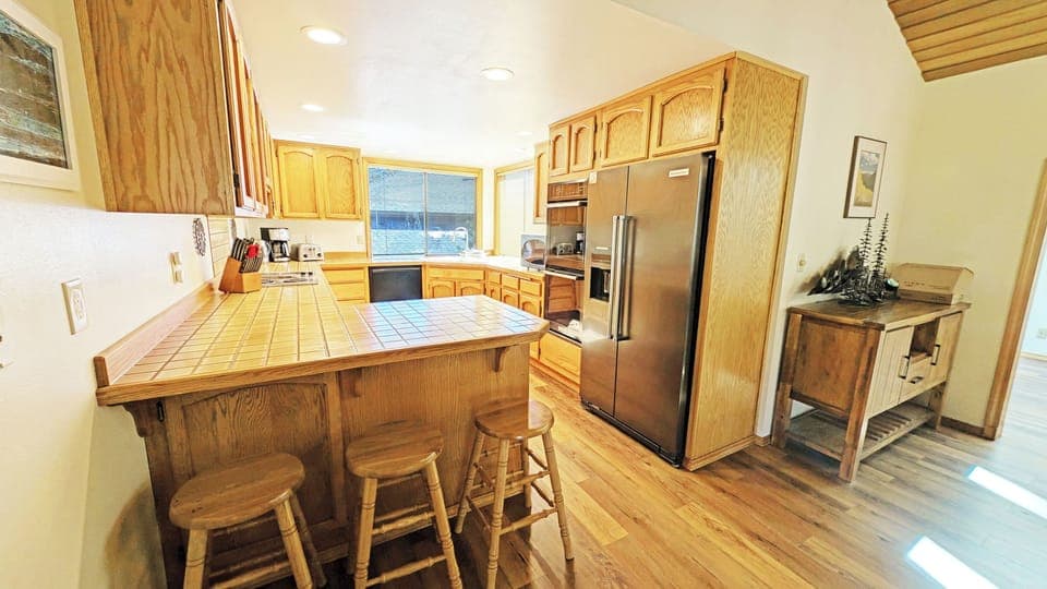 The Kitchen boasts updated appliances and 3 stools at the counter