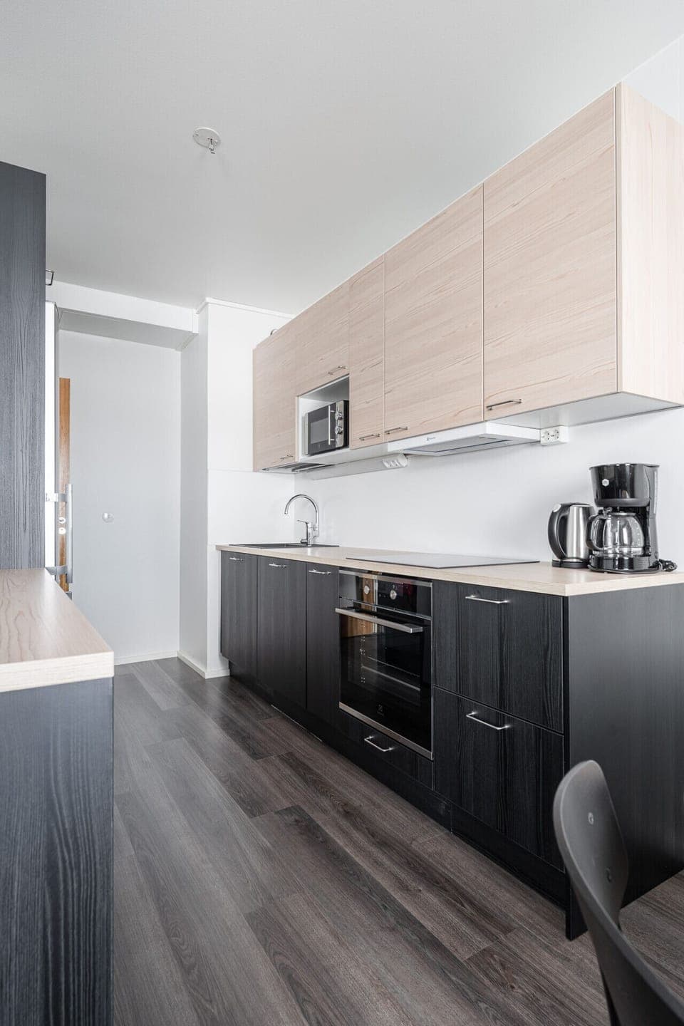The modern kitchen features integrated appliances and ample counter space, making it easy to keep things organized during your stay.