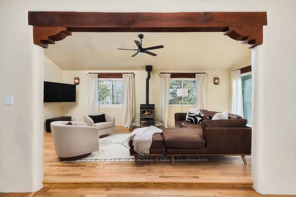 Upstairs living room. Gas fireplace. Timber framing and wood floors. 