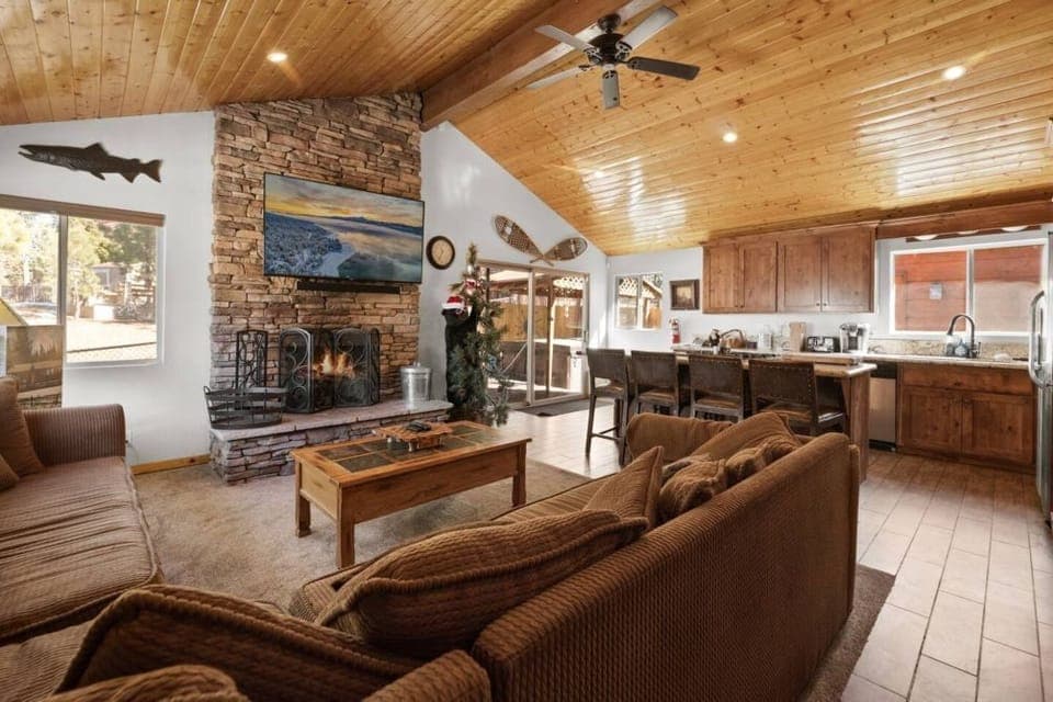 Gather around in our inviting living room, where rustic charm and modern comfort meet by a warm fireplace