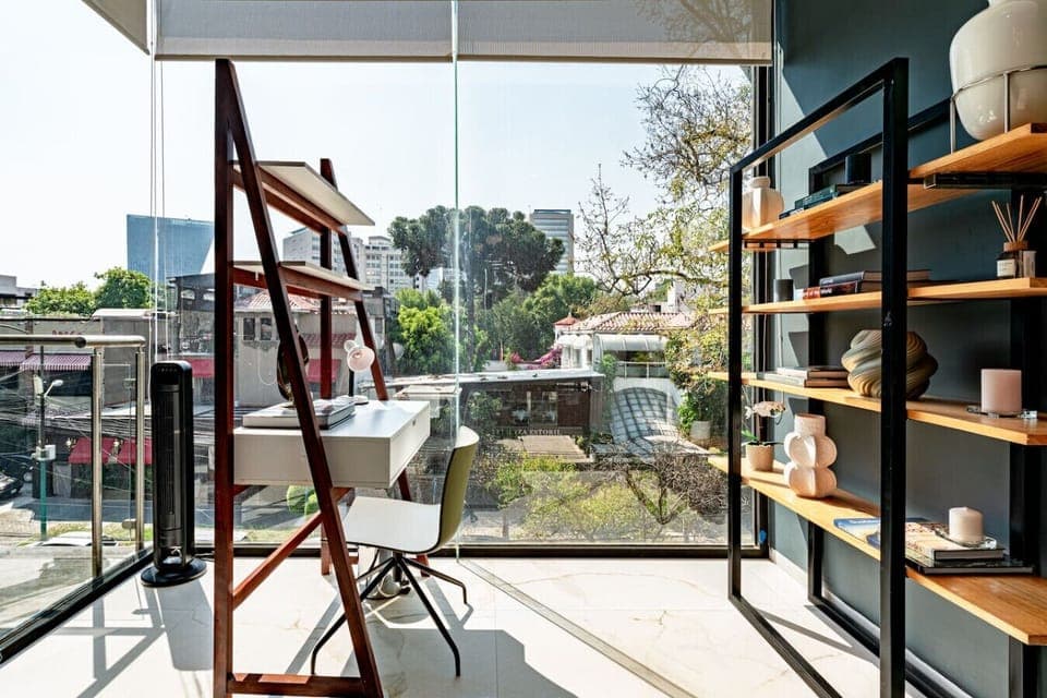 Floor-to-ceiling windows bring in light and a serene outdoor view from the lounge