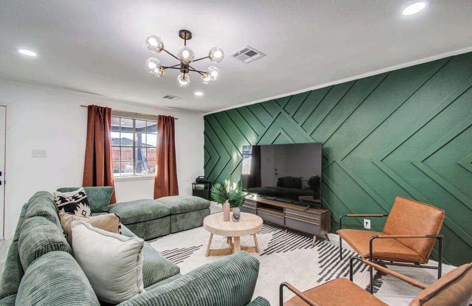 This living room’s comfortable seating and rich green walls create an air of sophistication with homages to the south scattered throughout – after all, you are in Texas!