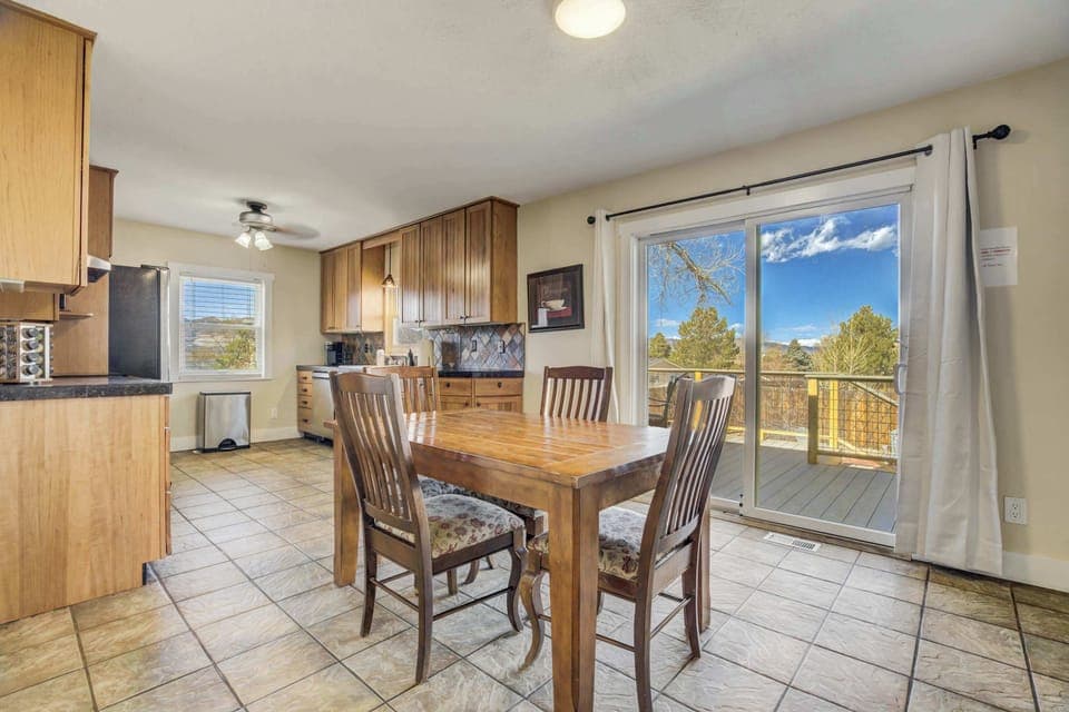 Bright and open dining area with direct access to the deck, offering scenic views and plenty of natural light.




