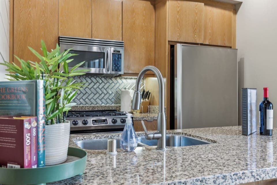 Welcome to our airy kitchen! With modern appliances, stylish countertop, and a charming dining nook, it’s perfect for cooking and socializing. This inviting space is ready for your culinary adventures and unforgettable meals!