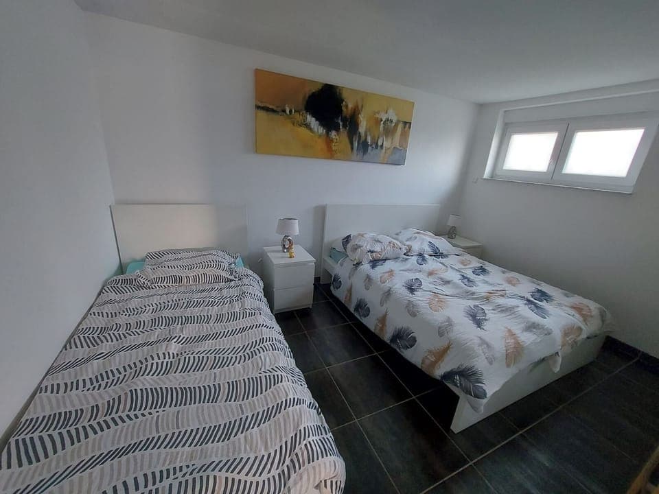 Bedroom with 1 single and 1 double bed an a big wardrobe for your clothes

