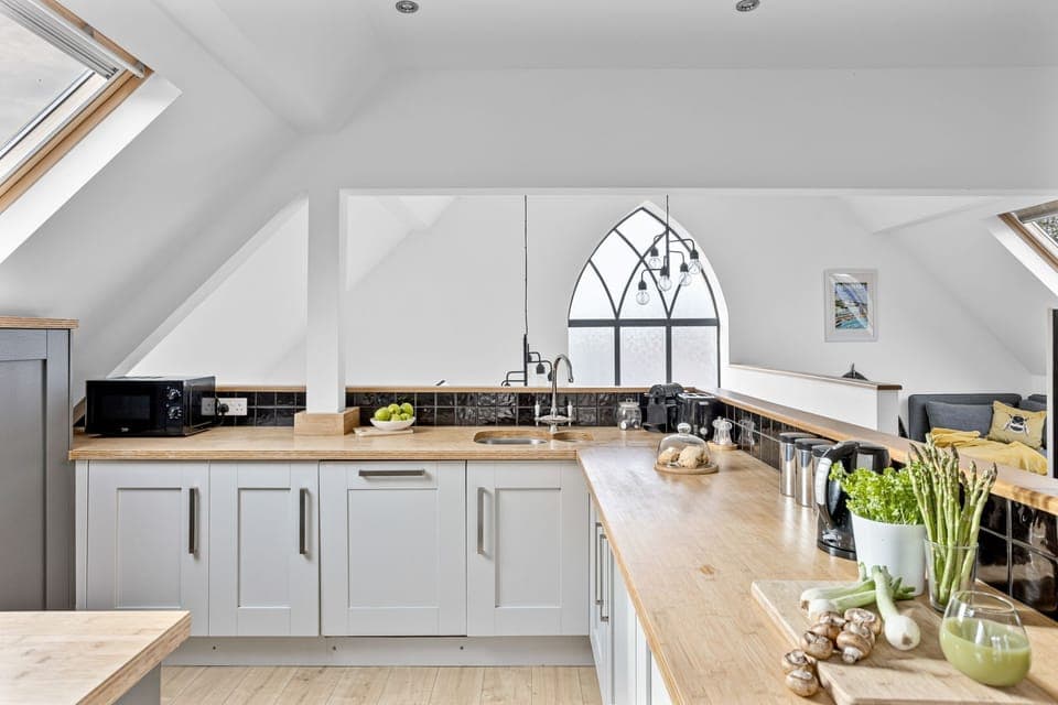 Modern kitchen with dishwasher, microwave, toast, kettle and coffee machine - Midholm Chapel