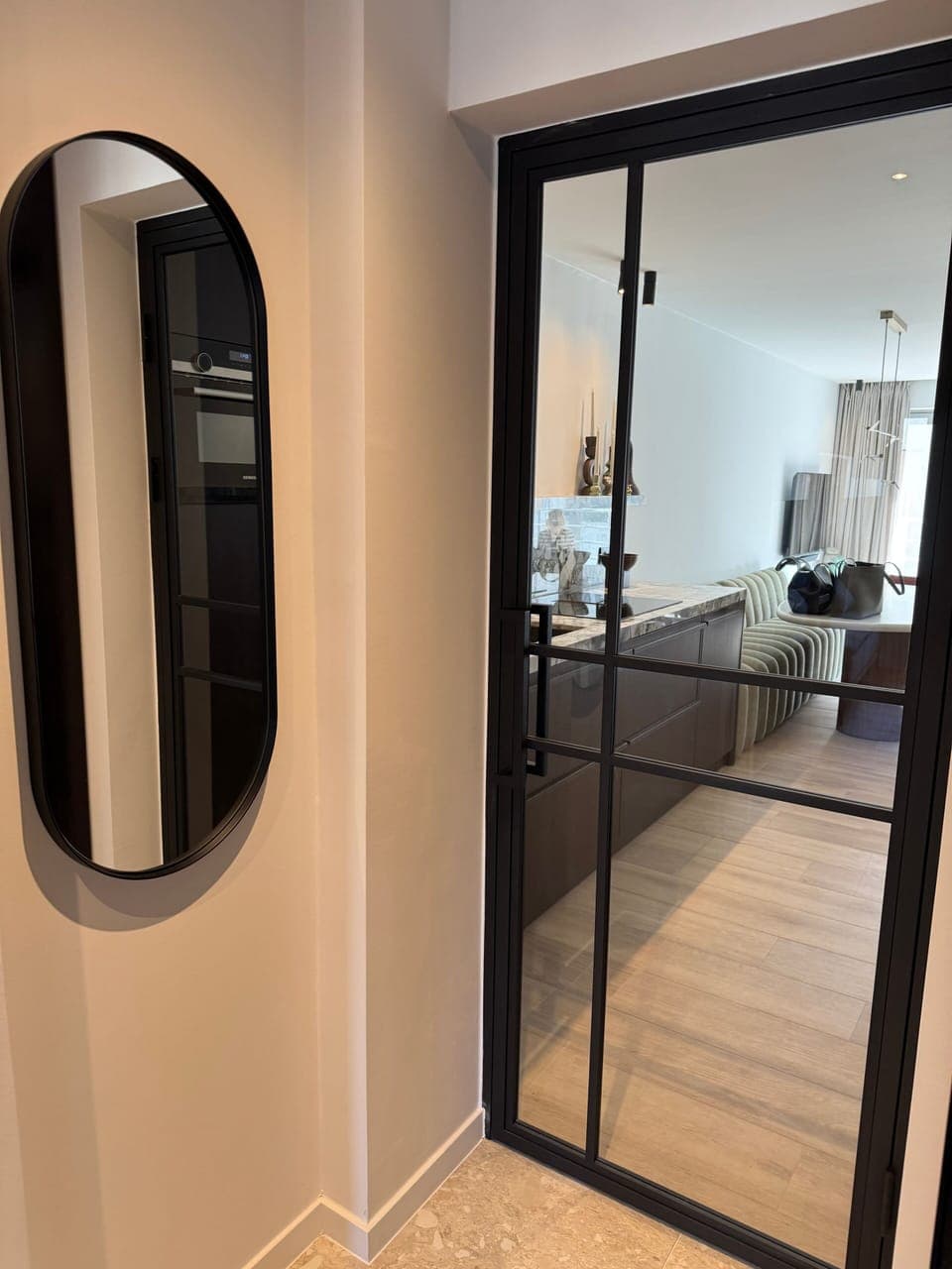 Refined hallway with glass doors and minimal design.