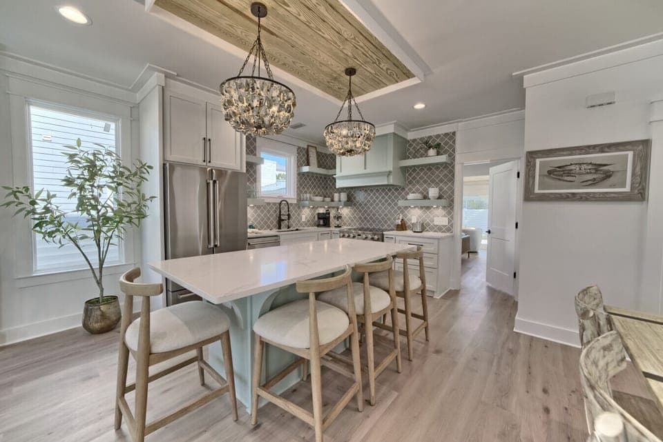 Chic lighting, sleek countertops, and open shelving make this kitchen a true standout.