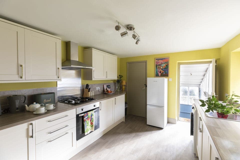 Palace Garden Cottage - the contemporary kitchen with a door leading out to the garden