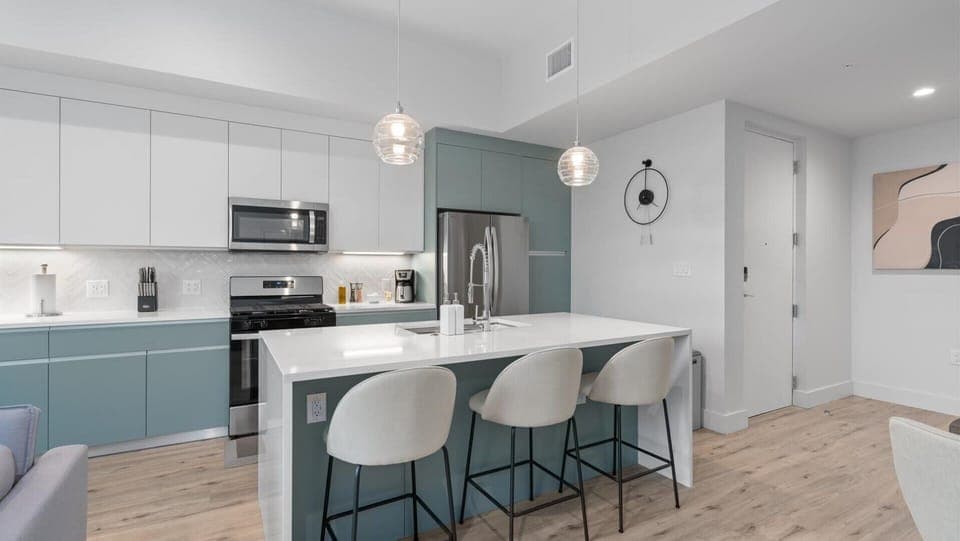 Contemporary kitchen with modern appliances and centered island with bar seating