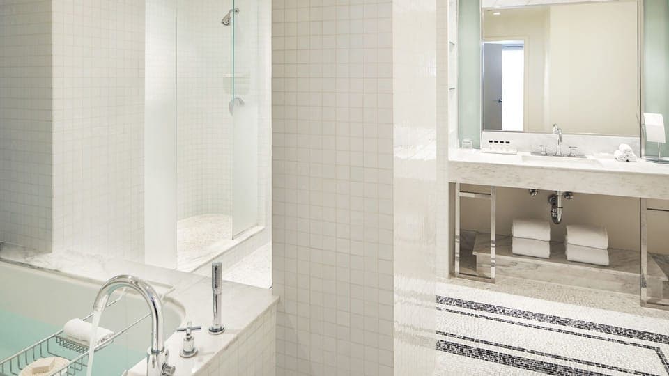 Refresh in a bright spa-style bathroom with glass shower.