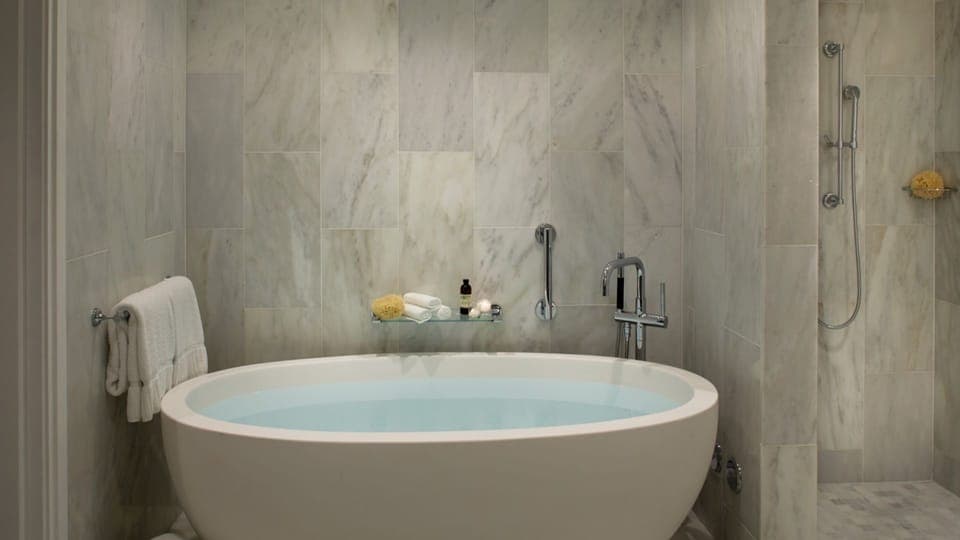 Recharge with a deep tub and rainfall-style shower nearby.