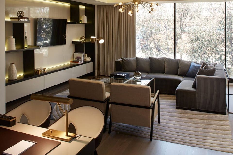 Unwind in a sunlit lounge with sleek, modern comfort.
