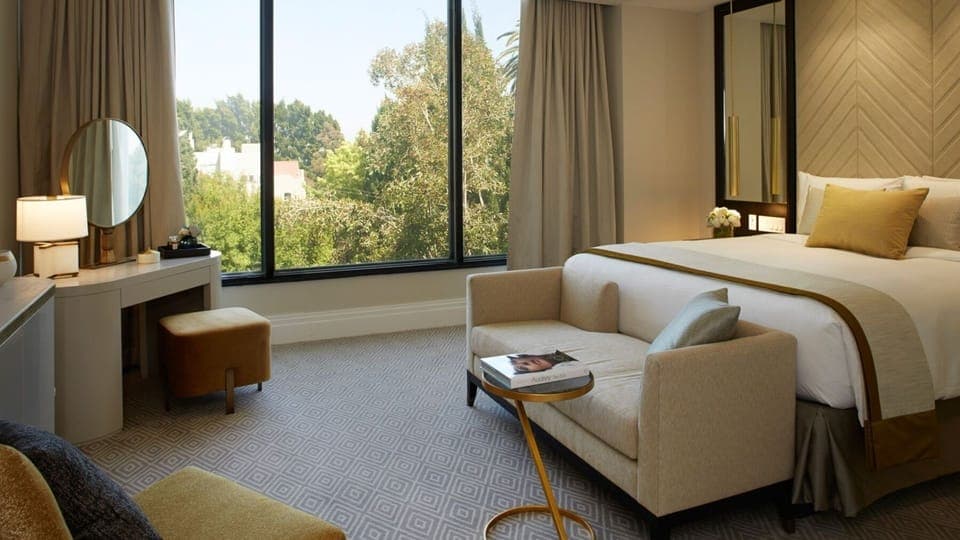 Sink into a king bed with layered pillows and calm decor.