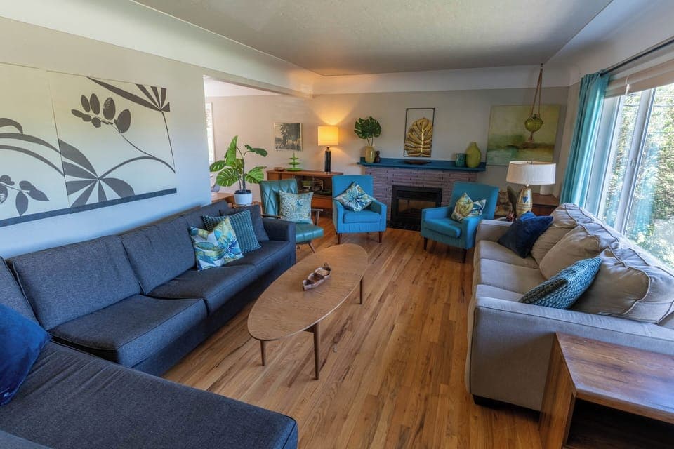 Spacious, sun-drenched living room offering sweeping views of Horner Park. 