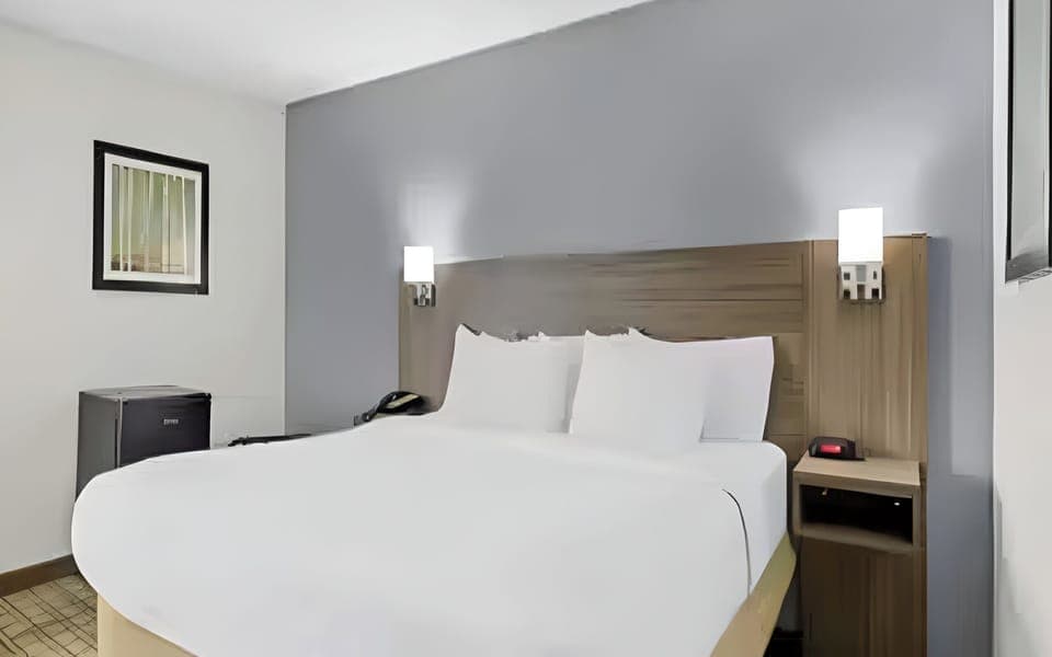 Drift off easily in a cozy bed with soft pillows.