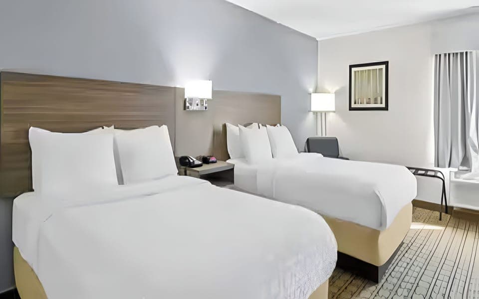 Unwind in crisp linens with roomy double-queen comfort.