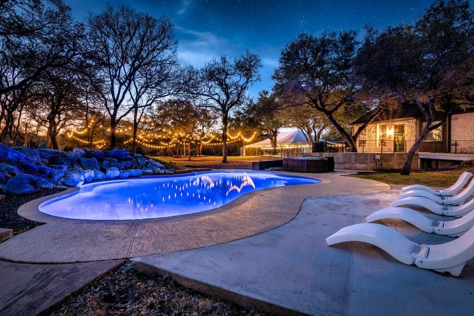 Twilight escape with a glowing pool and cozy, light-filled ambiance.
