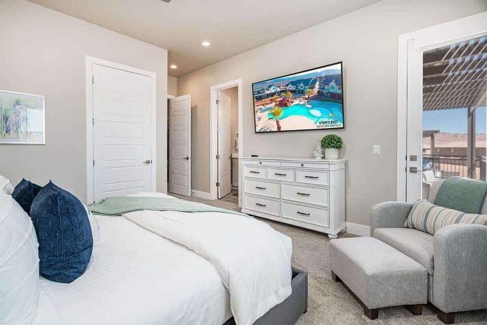 #52 - Master bedroom #2 upstairs with TV, chair and balcony with